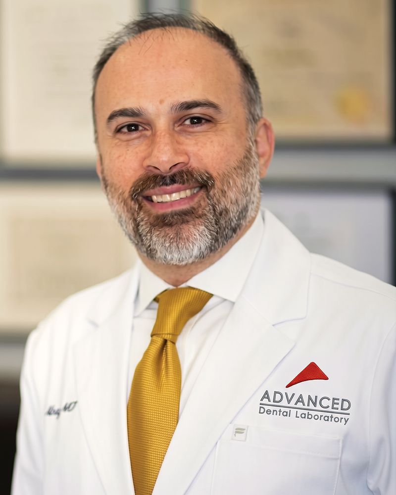 Portrait of David Abayev in a white lab coat